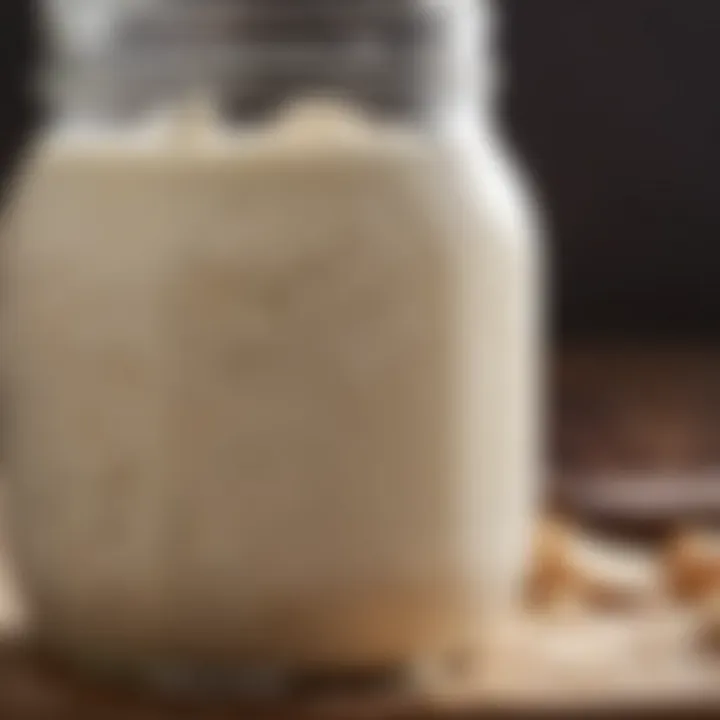 Close-up of a bubbling sourdough starter in a glass jar