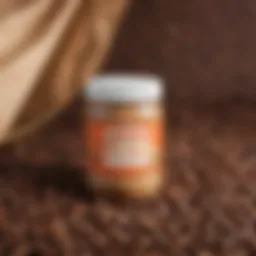 A jar of caffeinated peanut butter next to coffee beans and peanuts
