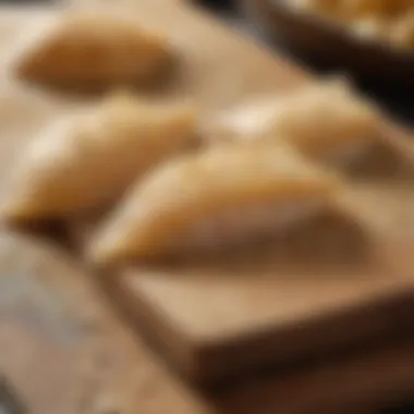 Close-up of fresh sand dabs on a cutting board, highlighting their delicate texture