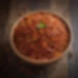 Vibrant display of Aleppo chilli flakes in a rustic wooden bowl