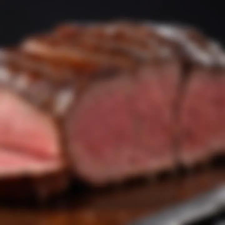 A close-up of a slice of roasted beef showcasing its perfect marbling and tenderness.