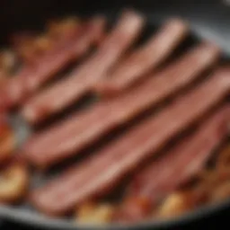 A perfectly fried strip of bacon sizzling in a skillet