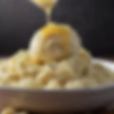 A close-up of creamy mashed potatoes with a pat of butter melting on top.