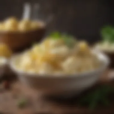 A beautifully garnished bowl of mashed potatoes with herbs and spices sprinkled on top.